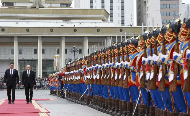 Russian President Vladimir Putin and Mongolian President Ukhnaagiin Khurelsukh, left, attend a welcome ceremony in Sukhbaatar Square in Ulaanbaatar, Mongolia, Tuesday, Sept. 3, 2024. (Vyacheslav Prokofyev, Sputnik, Kremlin Pool Photo via AP)