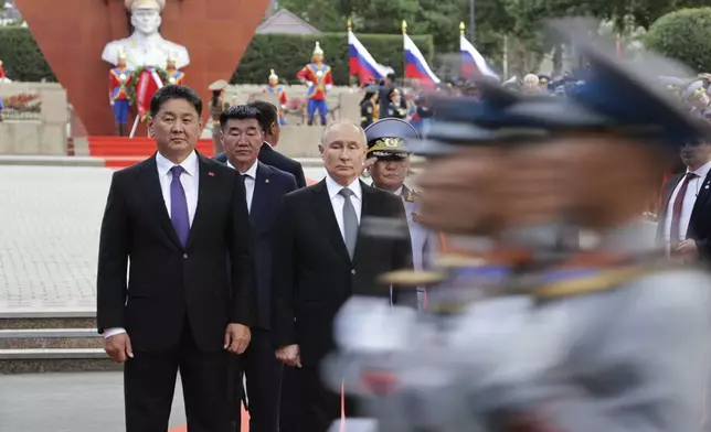 Russian President Vladimir Putin, center, and Mongolian President Ukhnaagiin Khurelsukh, left, attend a ceremony near a monument to Soviet Marshal Zhukov in Ulaanbaatar, Mongolia, Tuesday, Sept. 3, 2024. (Vyacheslav Prokofyev, Sputnik, Kremlin Pool Photo via AP)