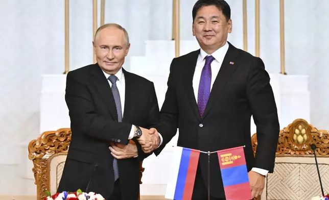 Russian President Vladimir Putin, left, and Mongolian President Ukhnaagiin Khurelsukh shake hands as they make a statement following the Russian-Mongolian talks at the Government Palace in Ulaanbaatar, Mongolia, Tuesday, Sept. 3, 2024. (Kristina Kormilitsyna, Sputnik, Kremlin Pool Photo via AP)