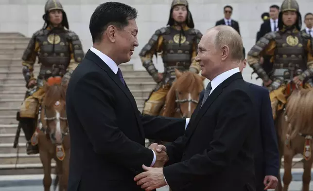 Russian President Vladimir Putin, right, and Mongolian President Ukhnaagiin Khurelsukh attend a welcome ceremony in Sukhbaatar Square in Ulaanbaatar, Mongolia, Tuesday, Sept. 3, 2024. (Vyacheslav Prokofyev, Sputnik, Kremlin Pool Photo via AP)