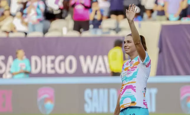 San Diego Wave's Alex Morgan waves before the start of an NWSL soccer game against the North Carolina Courage on Sunday, Sept. 8 2024, in San Diego. (Sandy Huffaker/The San Diego Union-Tribune via AP)