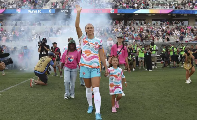 San Diego Wave's Alex Morgan waves before the start of an NWSL soccer game against the North Carolina Courage on Sunday, Sept. 8 2024, in San Diego. (Sandy Huffaker/The San Diego Union-Tribune via AP)