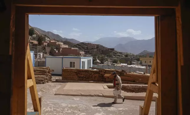 A construction worker walks outside the Great Mosque of Tinmel which dates back to the 12th century and suffered significant damage during a 2023 earthquake, in the Atlas mountain village of Tinmel, outside of Marrakech, Morocco, Thursday, Sept. 5, 2024. (AP Photo/Mosa'ab Elshamy)