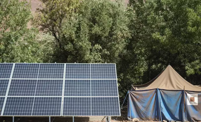 A tent for people displaced by the 2023 earthquake sits next to solar panels, in the Atlas mountain village of Tinmel, outside of Marrakech, Morocco, Thursday, Sept. 5, 2024. (AP Photo/Mosa'ab Elshamy)