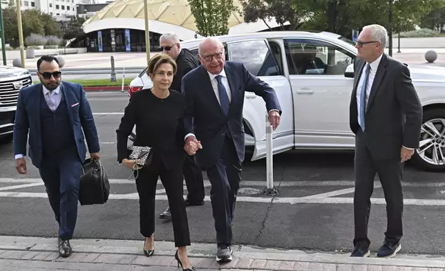 Rupert Murdoch, center, and his wife Elena Zhukova Murdoch arrive at the Second Judicial District Court in Reno, Nev., Monday Sept. 16, 2024. (AP Photo/Andy Barron)