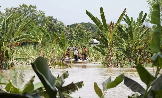 Local residents travel by boat on a flooded road in Naypyitaw, Myanmar, Saturday, Sept. 14, 2024. (AP Photo/Aung Shine Oo)