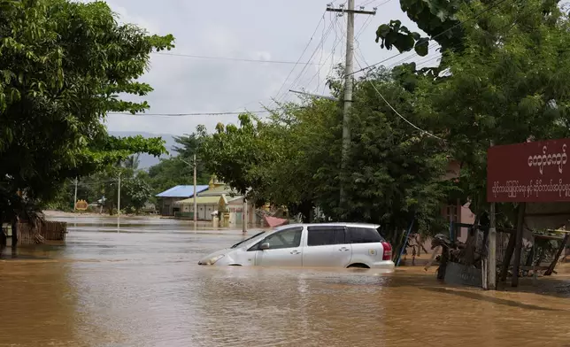 A car is submerged on a flooded road in Naypyitaw, Myanmar, Saturday, Sept. 14, 2024. (AP Photo/Aung Shine Oo)