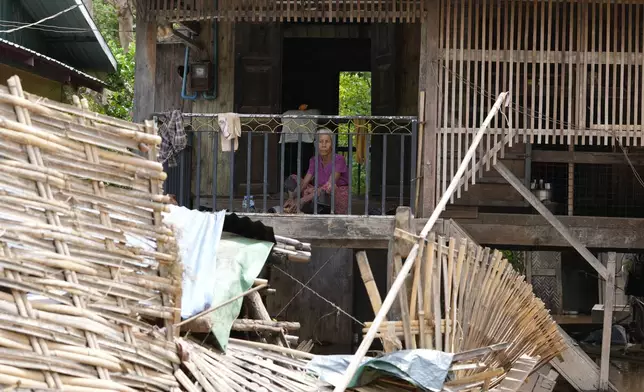 A women rests near a flooded road in Naypyitaw, Myanmar, Saturday, Sept. 14, 2024. (AP Photo/Aung Shine Oo)