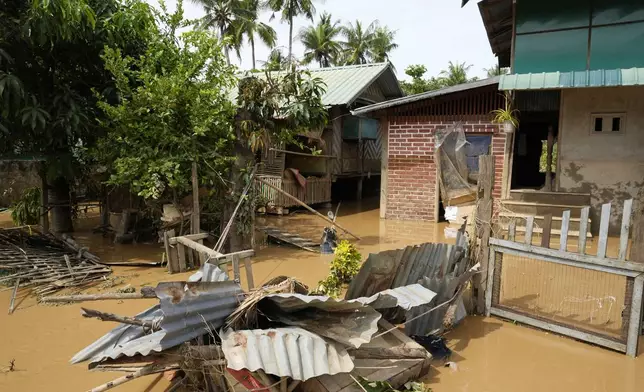 Debris from half-submerged residences floats on a flooded road in Naypyitaw, Myanmar, Saturday, Sept. 14, 2024. (AP Photo/Aung Shine Oo)