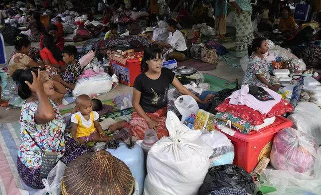 Flood victims take rest at temporary camp opened at monastery in Naypyitaw, Myanmar, Sunday, Sept. 15, 2024. (AP Photo/Aung Shine Oo)