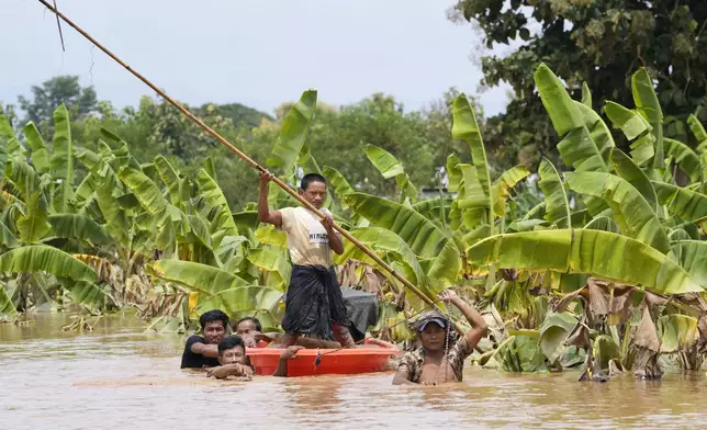 Local residents travel by small boat on a flooded road in Naypyitaw, Myanmar, Saturday, Sept. 14, 2024. (AP Photo/Aung Shine Oo)