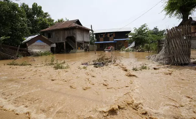 Debris from half-submerged residences float on a flooded road in Naypyitaw, Myanmar, Saturday, Sept. 14, 2024. (AP Photo/Aung Shine Oo)
