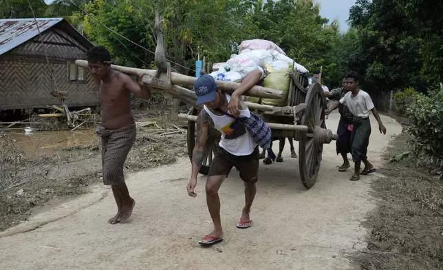 Local residents carry food on their cart, in Naypyitaw, Myanmar, Tuesday, Sept. 17, 2024. (AP Photo/Aung Shine Oo)