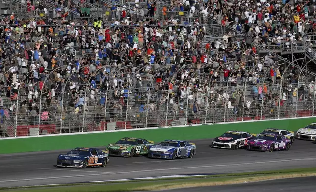 Joey Logano (22) leads a line of cars during a NASCAR Cup Series auto race at Atlanta Motor Speedway, Sunday, Sept. 8, 2024, in Hampton, Ga. (Hyosub Shin/Atlanta Journal-Constitution via AP)