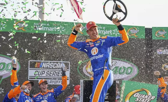 Joey Logano, center, celebrates in Victory Lane after winning a NASCAR Cup Series auto race Sunday, Sept. 8, 2024, in Hampton, Ga. (AP Photo/Jason Allen)