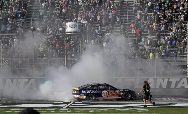 Joey Logano (22) celebrates with a burnout after winning a NASCAR Cup Series auto race at Atlanta Motor Speedway, Sunday, Sept. 8, 2024, in Hampton, Ga. (Hyosub Shin/Atlanta Journal-Constitution via AP)