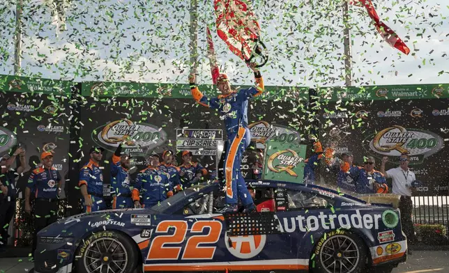 Joey Logano, center, celebrates after winning a NASCAR Cup Series auto race at Atlanta Motor Speedway, Sunday, September 8, 2024, in Hampton, Ga. (Hyosub Shin/Atlanta Journal-Constitution via AP)