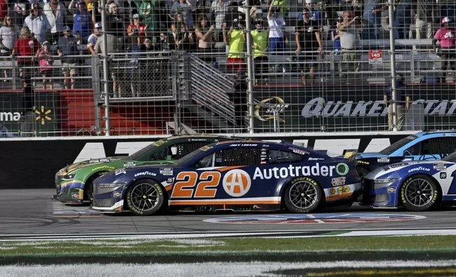 Joey Logano (22) races against Daniel Suarez, front right, during a NASCAR Cup Series auto race at Atlanta Motor Speedway, Sunday, Sept. 8, 2024, in Hampton, Ga. (Hyosub Shin/Atlanta Journal-Constitution via AP)