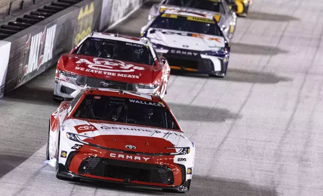 Bubba Wallace (23) leads Josh Bilicki (66) and Denny Hamlin (11) during a NASCAR Cup Series auto race, Saturday, Sept. 21, 2024, in Bristol, Tenn. (AP Photo/Wade Payne)