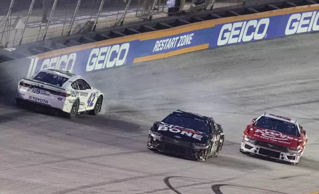 John Hunter Nemechek (42) spins while coming out of Turn 4 as Kaz Grala (15) and Josh Bilicki (66) avoid him during a NASCAR Cup Series auto race, Saturday, Sept. 21, 2024, in Bristol, Tenn. (AP Photo/Wade Payne)