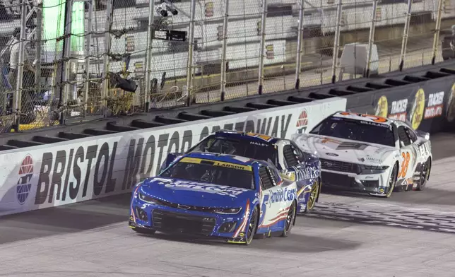 Kyle Larson (5) leads Justin Haley (51) and Todd Gilliland (38) during a NASCAR Cup Series auto race, Saturday, Sept. 21, 2024, in Bristol, Tenn. (AP Photo/Wade Payne)