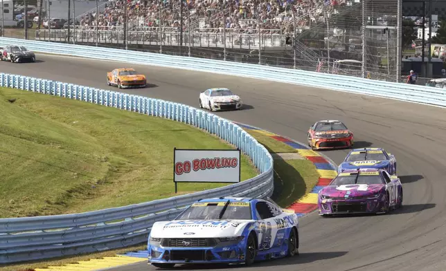 Chase Briscoe (14) drives through the during a NASCAR Cup Series auto race, Sunday, Sept. 15, 2024, in Watkins Glen, N.Y. (AP Photo/Lauren Petracca)