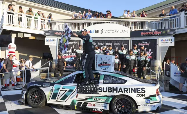 Chris Buescher (17) celebrates winning a NASCAR Cup Series auto race, Sunday, Sept. 15, 2024, in Watkins Glen, N.Y. (AP Photo/Lauren Petracca)