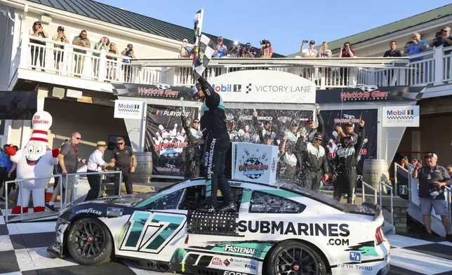 Chris Buescher (17) celebrates winning a NASCAR Cup Series auto race, Sunday, Sept. 15, 2024, in Watkins Glen, N.Y. (AP Photo/Lauren Petracca)