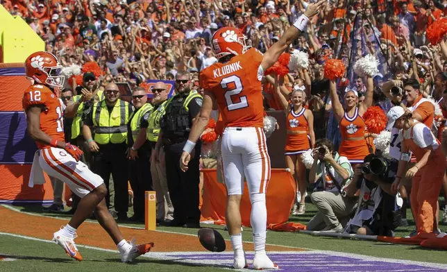 Clemson quarterback Cade Klubnik (2) celebrates a 55-yard touchdown run with wide receiver Bryant Wesco Jr. (12) during the first half of an NCAA college football game against North Carolina State Saturday, Sept. 21, 2024, in Clemson, S.C. (AP Photo/Artie Walker Jr.)