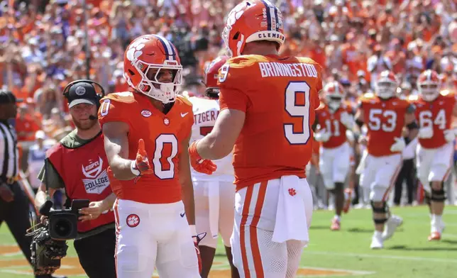 Clemson wide receiver Antonio Williams (0) celebrates a 2-yard touchdown reception with tight end Jake Briningstool (9) during the first half of an NCAA college football game against North Carolina State Saturday, Sept. 21, 2024, in Clemson, S.C. (AP Photo/Artie Walker Jr.)