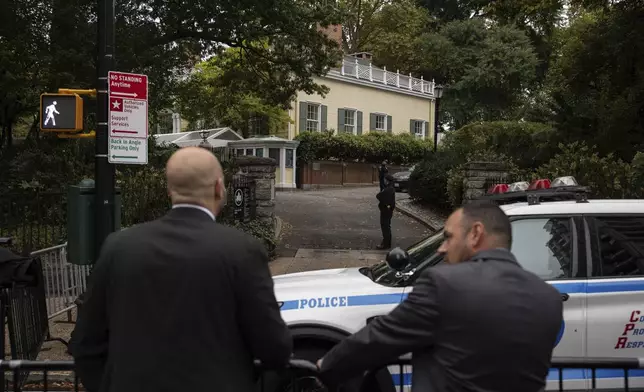 Police officers stand outside Gracie Mansion, the official residence of New York City Mayor Eric Adams, Thursday, Sep. 26, 2024, in New York. (AP Photo/Yuki Iwamura)