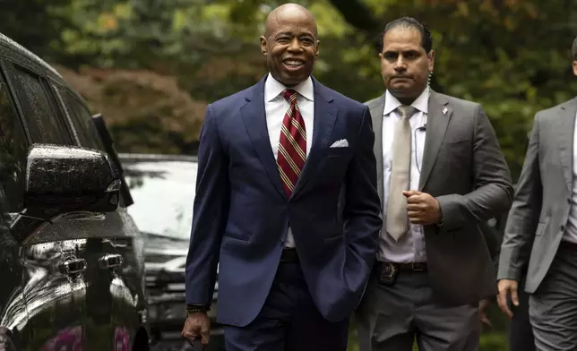 New York City Mayor Eric Adams, left, exits Gracie Mansion, the official residence of the mayor, Thursday, Sept. 26, 2024, in New York. (AP Photo/Yuki Iwamura)