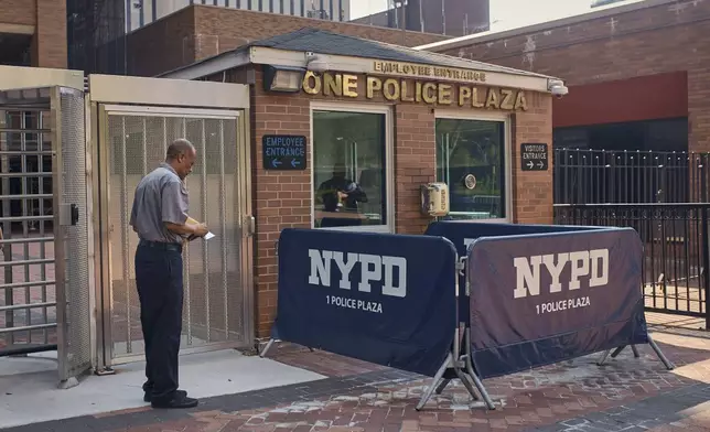 A man styands outside One Police Plaza NYPD Headquarters on Friday, Sept. 13, 2024, in New York. (AP Photo/Andres Kudacki)