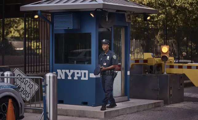 A police officer stands guard outside One Police Plaza NYPD Headquarters on Friday, Sept. 13, 2024, in New York. (AP Photo/Andres Kudacki)