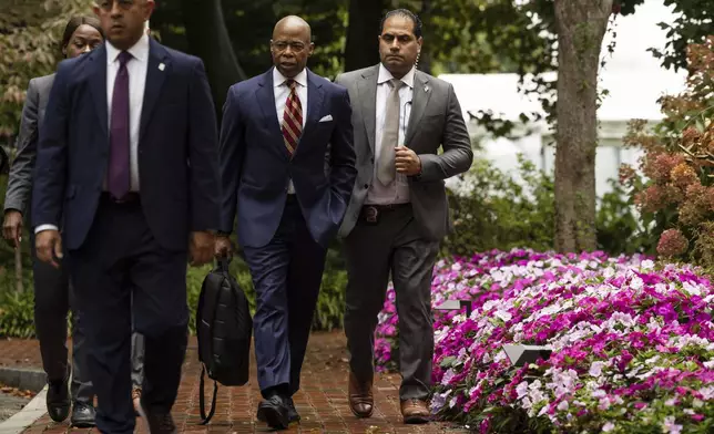 New York City Mayor Eric Adams, second right, exits Gracie Mansion, the official residence of the mayor, Thursday, Sept. 26, 2024, in New York. (AP Photo/Yuki Iwamura)