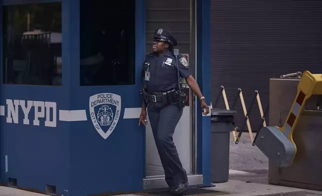 A police officer stands guard outside One Police Plaza NYPD Headquarters on Friday, Sept. 13, 2024, in New York. (AP Photo/Andres Kudacki)