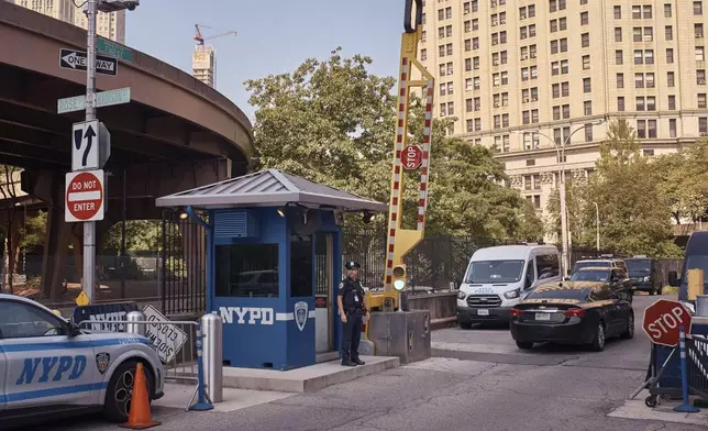 A police officer stands guard outside One Police Plaza NYPD Headquarters on Friday, Sept. 13, 2024, in New York. (AP Photo/Andres Kudacki)