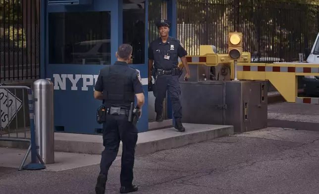 Police officers guard outside One Police Plaza NYPD Headquarters on Friday, Sept. 13, 2024, in New York. (AP Photo/Andres Kudacki)