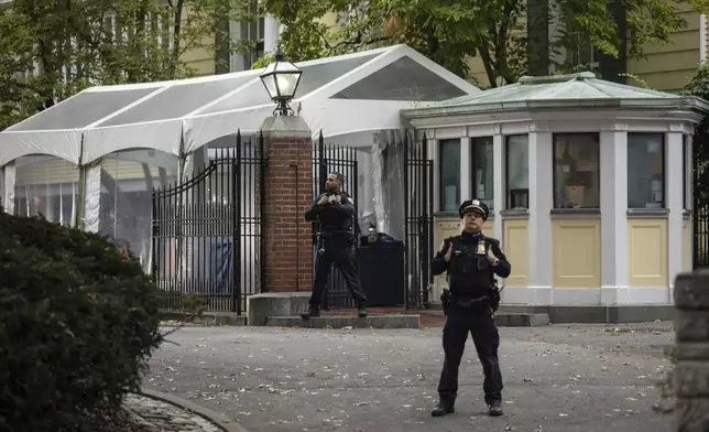 A NYPD officer stands outside Gracie Mansion, the official residence of New York City Mayor Eric Adams, Thursday, Sep. 26, 2024, in New York. (AP Photo/Yuki Iwamura)