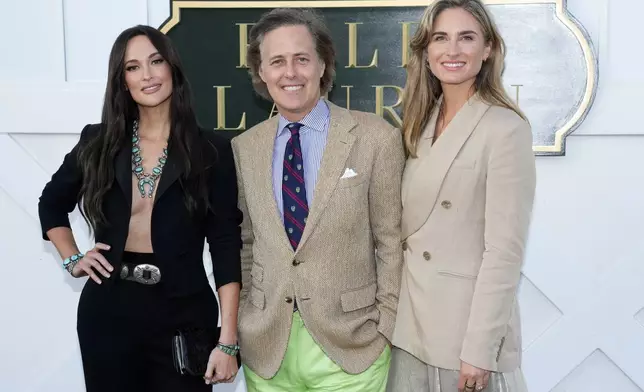 Kacey Musgraves, from left, David Lauren and Lauren Bush Lauren attend the Ralph Lauren Spring/Summer 2025 fashion show as part of New York Fashion Week on Thursday, Sept. 5, 2024, at Khalily Stables in Bridgehampton, N.Y. (Photo by Charles Sykes/Invision/AP)