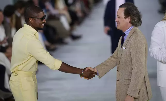 Usher, left, and David Lauren attend the Ralph Lauren Spring/Summer 2025 fashion show as part of New York Fashion Week on Thursday, Sept. 5, 2024, at Khalily Stables in Bridgehampton, N.Y. (Photo by Charles Sykes/Invision/AP)