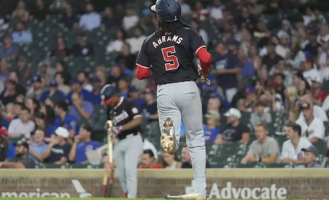 Washington Nationals' CJ Abrams (5) scores on a single by Andrés Chaparro during the first inning of a baseball game against the Chicago Cubs, Thursday, Sept. 19, 2024, in Chicago. (AP Photo/Erin Hooley)