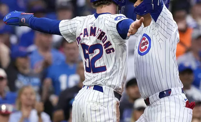 Chicago Cubs' Miguel Amaya, right, celebrates with Pete Crow-Armstrong after hitting a two-run home run during the fourth inning of a baseball game against the Washington Nationals in Chicago, Sunday, Sept. 22, 2024. (AP Photo/Nam Y. Huh)