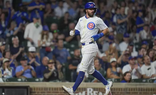 Chicago Cubs' Dansby Swanson scores on a single from Cody Bellinger during the first inning of a baseball game against the Washington Nationals, Thursday, Sept. 19, 2024, in Chicago. (AP Photo/Erin Hooley)