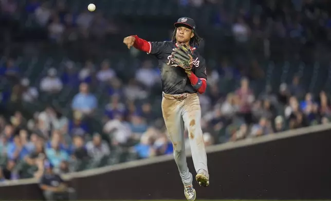 Washington Nationals shortstop CJ Abrams throws to first baseman Juan Yepez to force out Chicago Cubs' Ian Happ during the first inning of a baseball game Thursday, Sept. 19, 2024, in Chicago. (AP Photo/Erin Hooley)