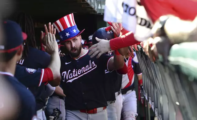 Washington Nationals' Joey Gallo celebrates with teammates in the dugout after hitting a three-run home run during the sixth inning of a baseball game against the Chicago Cubs in Chicago, Saturday, Sept. 21, 2024. (AP Photo/Paul Beaty)