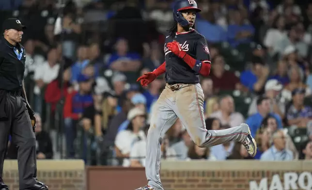 Washington Nationals' CJ Abrams scores on a double from James Wood during the third inning of a baseball game against the Chicago Cubs, Thursday, Sept. 19, 2024, in Chicago. (AP Photo/Erin Hooley)