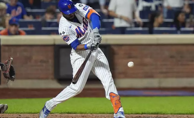 New York Mets' Starling Marte hits an RBI single during the 10th inning of a baseball game against the Washington Nationals, Monday, Sept. 16, 2024, in New York. (AP Photo/Frank Franklin II)