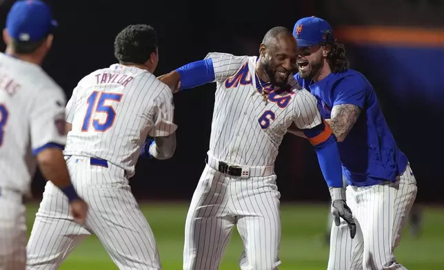 New York Mets' Starling Marte (6) celebrates with teammates after a baseball game against the Washington Nationals, Monday, Sept. 16, 2024, in New York. (AP Photo/Frank Franklin II)