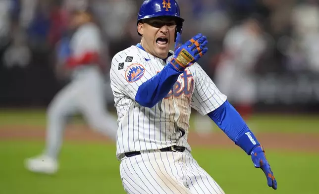 New York Mets' Jose Iglesias celebrates after hitting an RBI single during the eighth inning of a baseball game against the Washington Nationals, Monday, Sept. 16, 2024, in New York. (AP Photo/Frank Franklin II)